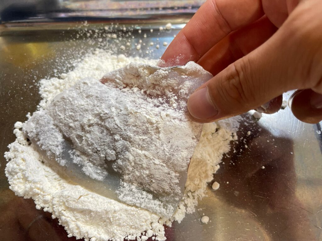 クロダイの切り身に小麦粉をまぶす画像